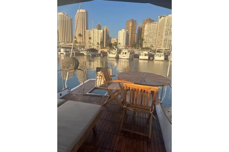 Slide: The Image of 1979 Cheoy Lee Sedan 35 yacht deck with city skyline view. - 6
