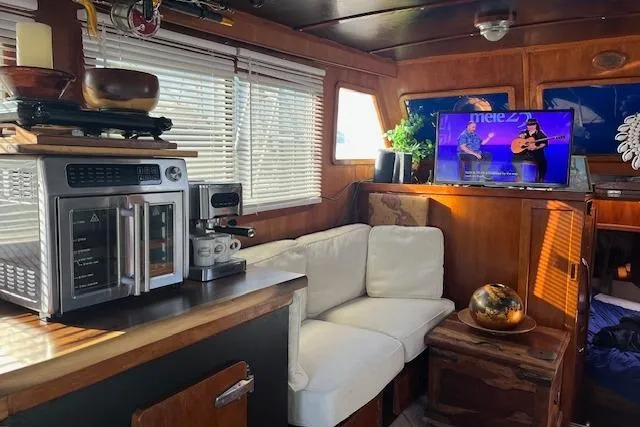 Slide: The Image of Interior of a 1979 Cheoy Lee Sedan 35 with cozy seating and modern appliances. - 9