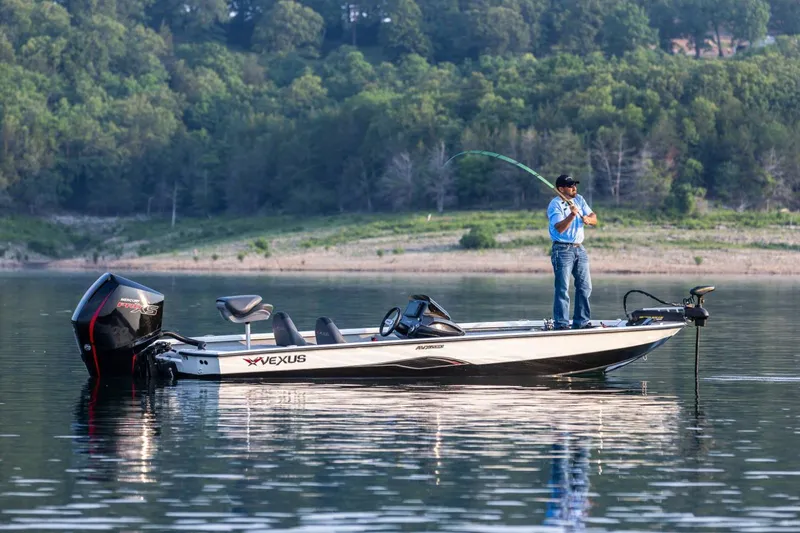 Slide: The Image of Manufacturer Provided Image: 2026 Vexus AVX 2080 boat on a lake with a person fishing. - 2