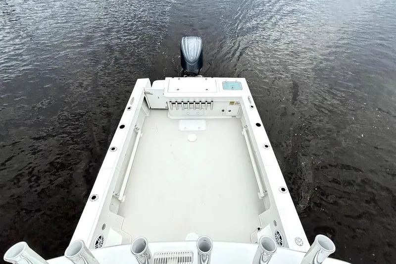 Slide: The Image of 2022 Parker 2320 Sport Cabin boat deck with outboard motor on water. - 4