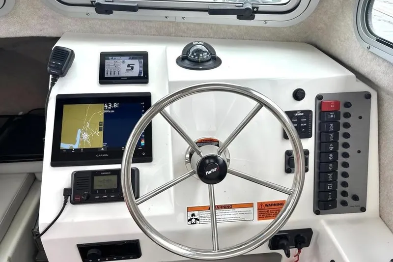 Slide: The Image of Steering console of 2022 Parker 2320 Sport Cabin with navigation and control panels. - 5