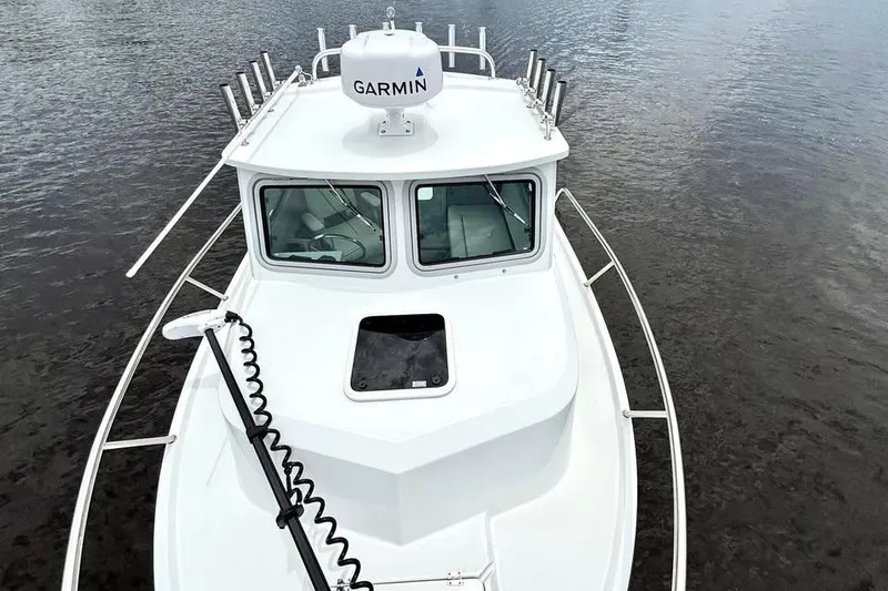 Slide: The Image of 2022 Parker 2320 Sport Cabin boat with Garmin radar on calm water. - 7