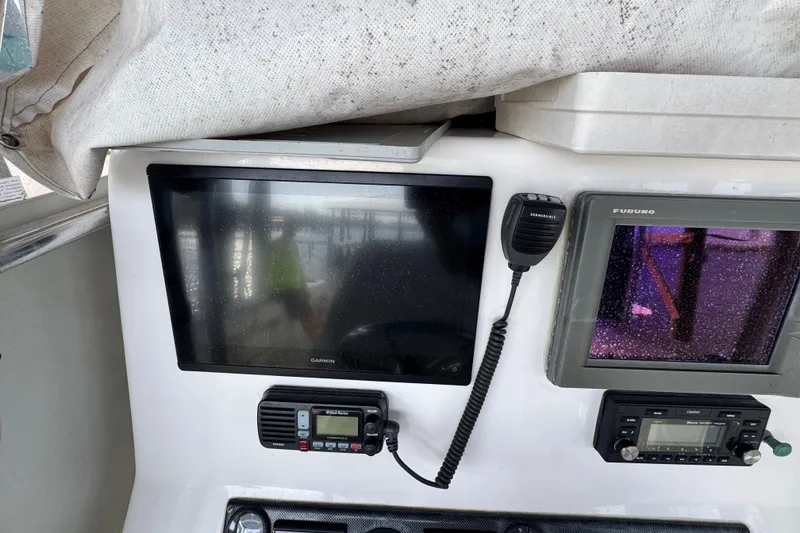Slide: The Image of 2006 Twin Vee 36 Center Console dashboard with Garmin and Furuno navigation systems. - 12