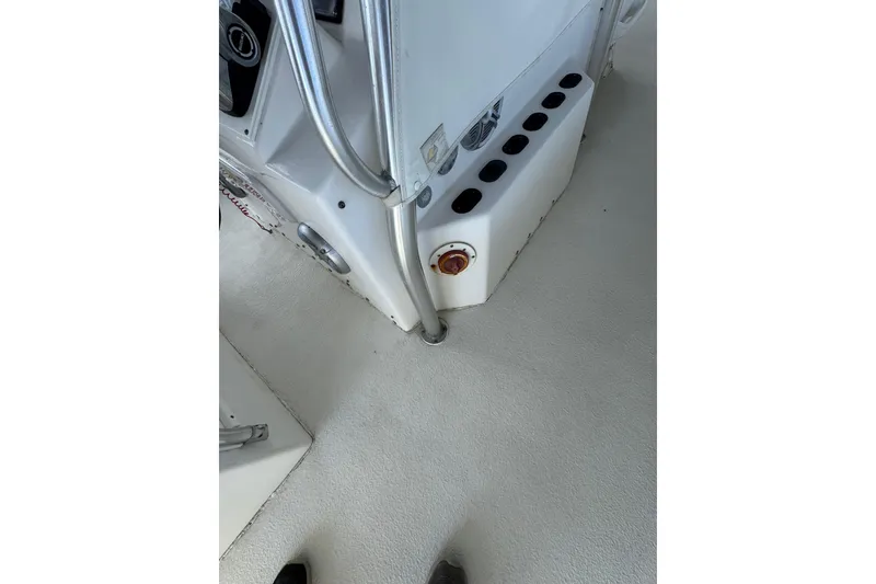 Slide: The Image of 2006 Twin Vee 36 Center Console interior with rod holders and control panel. - 13