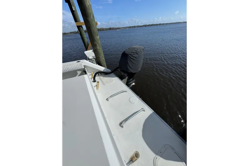 Slide: The Image of 2006 Twin Vee 36 Center Console boat docked by calm waters. - 17