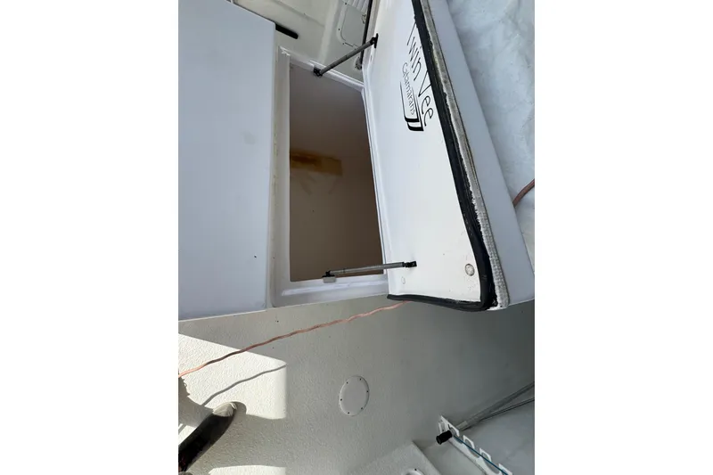 Slide: The Image of Open storage compartment on 2006 Twin Vee 36 Center Console boat. - 19