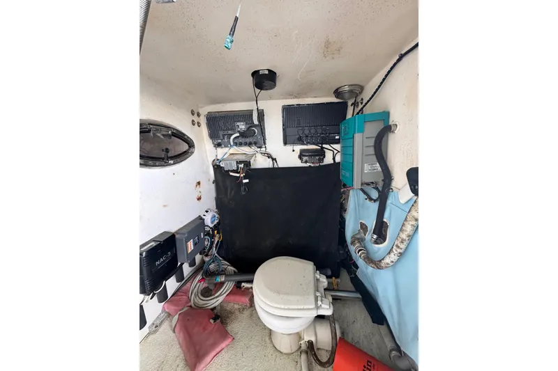 Slide: The Image of Interior of a 2006 Twin Vee 36 Center Console boat, featuring equipment and wiring. - 22