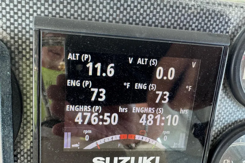 Slide: The Image of Close-up of a Suzuki engine display on a 2006 Twin Vee 36 Center Console boat. - 23