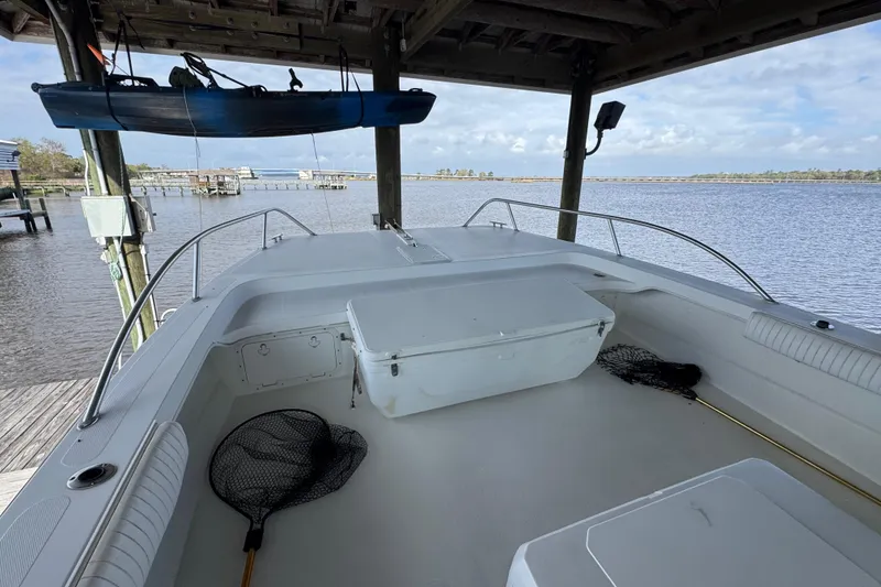 Slide: The Image of 2006 Twin Vee 36 Center Console boat docked, featuring spacious deck and fishing nets. - 24