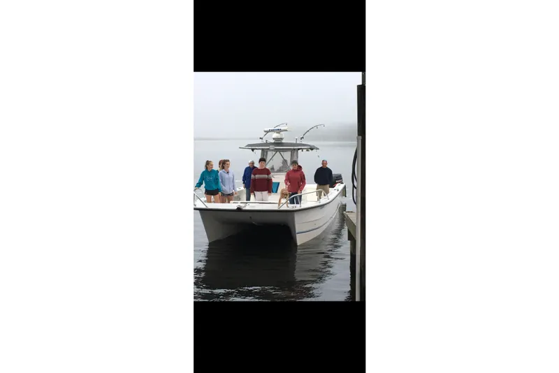 Slide: The Image of 2006 Twin Vee 36 Center Console boat with people onboard at a dock. - 28