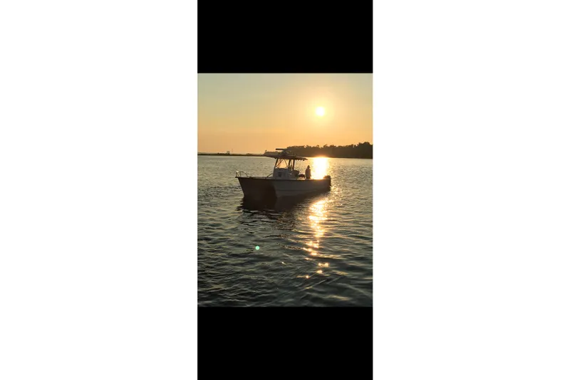 Slide: The Image of 2006 Twin Vee 36 Center Console boat at sunset on calm water. - 29
