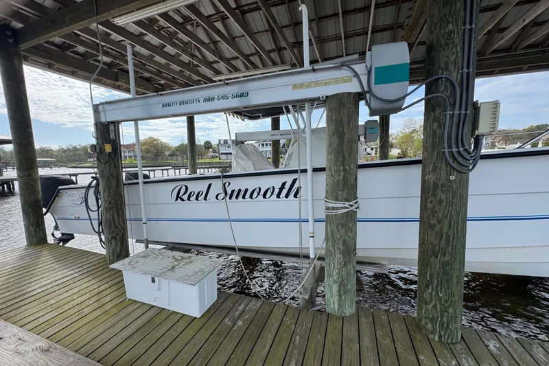 Slide: The Image of 2006 Twin Vee 36 Center Console boat docked under a wooden shelter. - 3