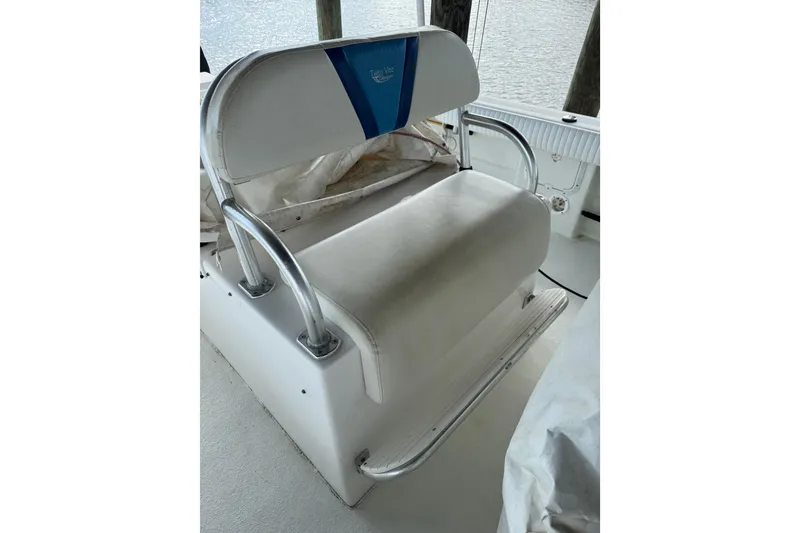 Slide: The Image of Twin Vee 36 Center Console 2006 boat seat with blue accent and metal armrests. - 5