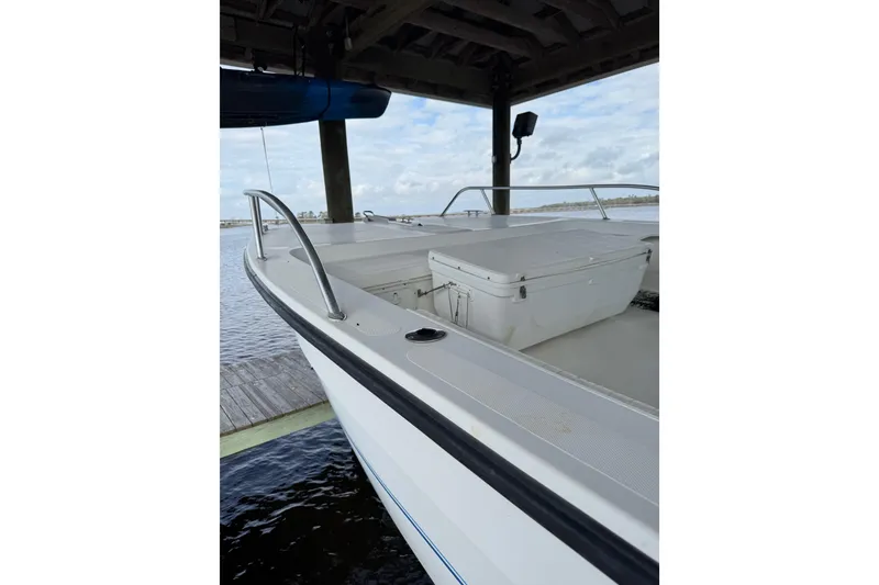 Slide: The Image of 2006 Twin Vee 36 Center Console boat docked under a wooden shelter. - 8