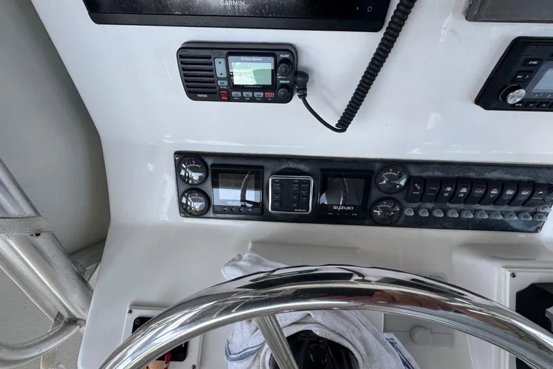 Slide: The Image of 2006 Twin Vee 36 Center Console dashboard with Garmin and Suzuki controls. - 9