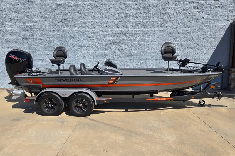 The Image of 2026 Vexus AVX1980 boat with trailer, gray and orange design, parked outdoors. - 2