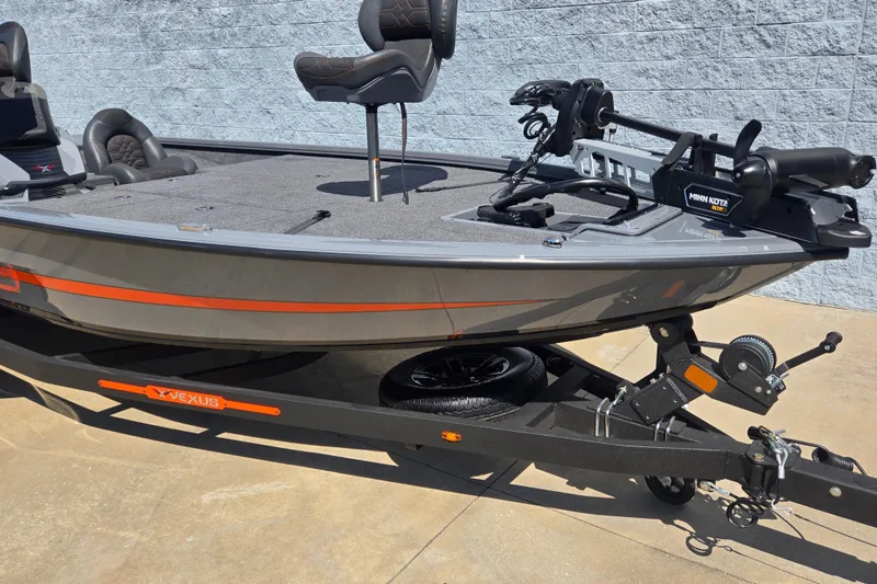 Slide: The Image of 2026 Vexus AVX1980 boat on trailer with Minn Kota motor, gray and orange design. - 4