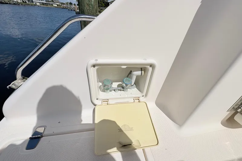 Slide: The Image of 2011 Pursuit OS 375 Offshore boat deck with built-in water faucet and storage compartment. - 12