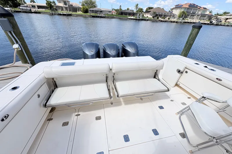 Slide: The Image of 2011 Pursuit OS 375 Offshore boat with seating and triple outboard motors. - 17