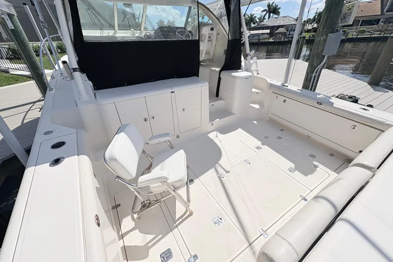 Slide: The Image of 2011 Pursuit OS 375 Offshore boat interior with seating and storage compartments. - 18