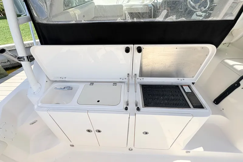 Slide: The Image of 2011 Pursuit OS 375 Offshore boat galley with sink and grill. - 19