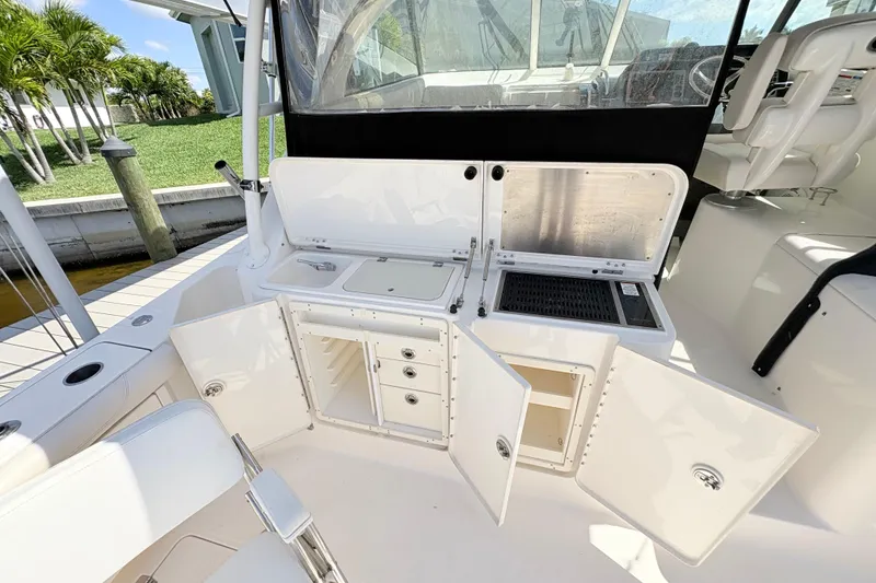 Slide: The Image of 2011 Pursuit OS 375 Offshore boat with open storage compartments and seating area. - 20