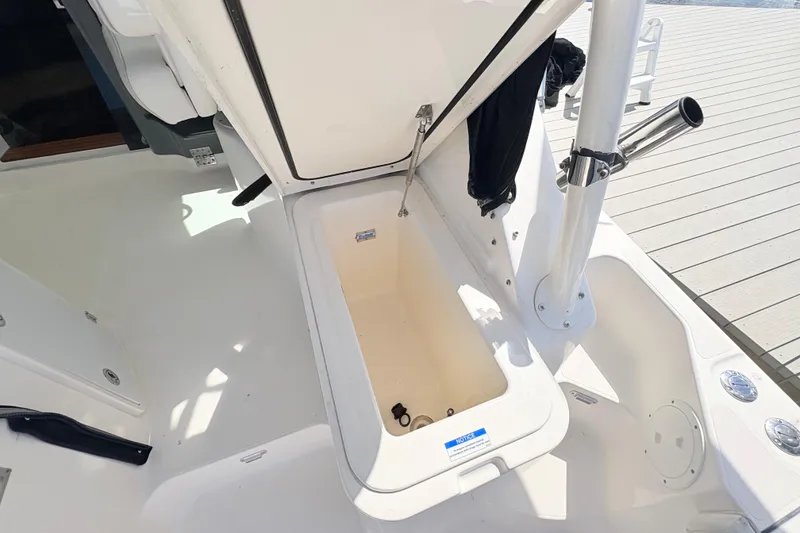 Slide: The Image of Open storage compartment on a 2011 Pursuit OS 375 Offshore boat deck. - 21
