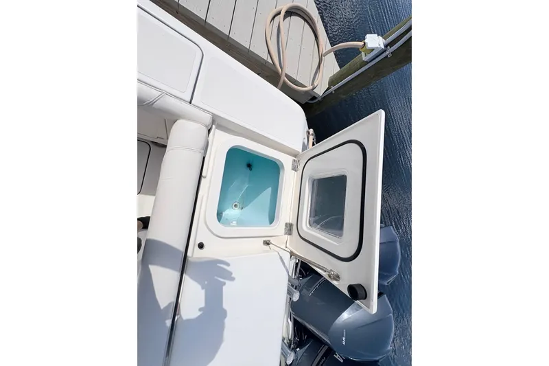 Slide: The Image of Open hatch on 2011 Pursuit OS 375 Offshore boat, dockside view. - 23