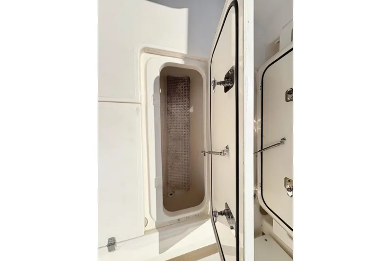 Slide: The Image of Open storage compartment on a 2011 Pursuit OS 375 Offshore boat. - 24