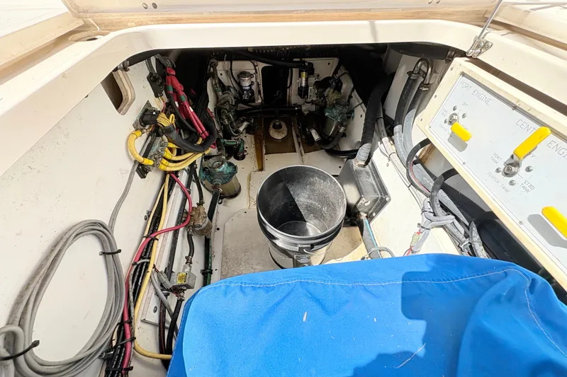 Slide: The Image of Engine compartment of a 2011 Pursuit OS 375 Offshore boat, showing wiring and controls. - 26