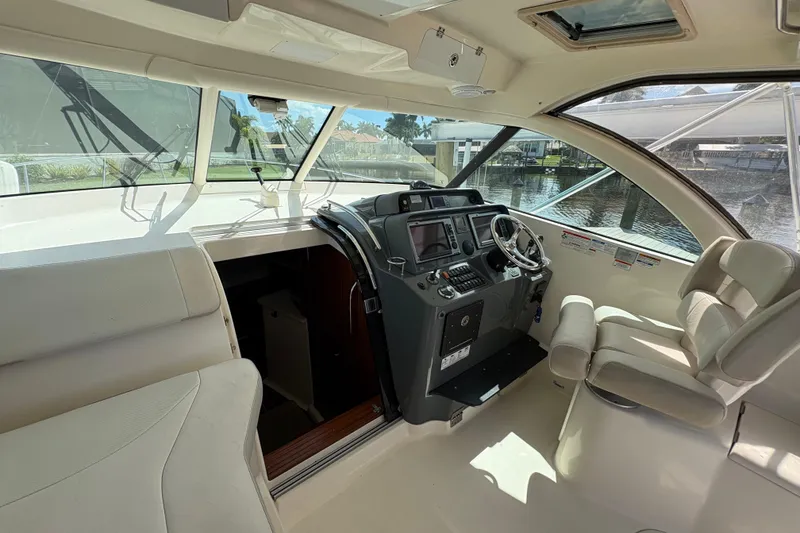 Slide: The Image of Interior of 2011 Pursuit OS 375 Offshore boat with helm and seating area. - 27