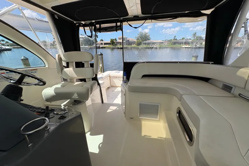 Slide: The Image of Interior of 2011 Pursuit OS 375 Offshore boat with seating and steering wheel, overlooking water. - 28