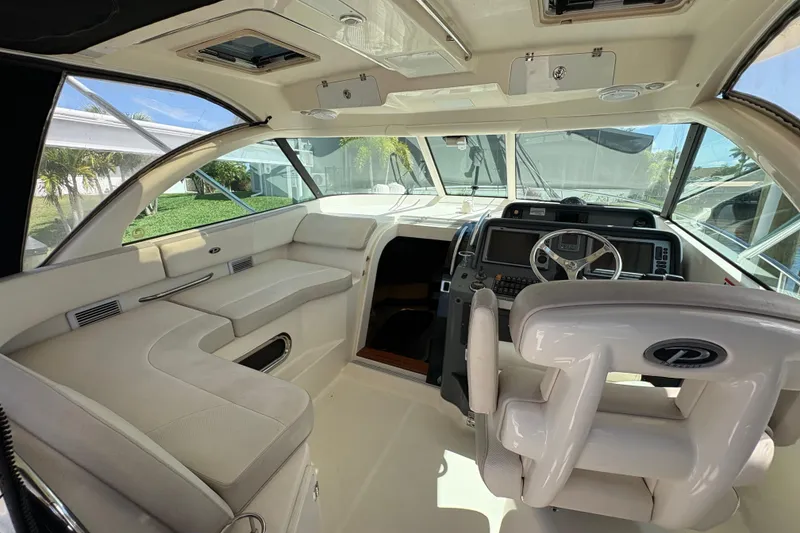 Slide: The Image of 2011 Pursuit OS 375 Offshore boat interior with helm, seating, and navigation equipment. - 30