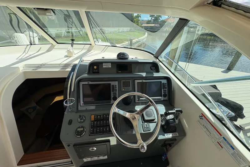 Slide: The Image of Helm of 2011 Pursuit OS 375 Offshore boat with navigation equipment and steering wheel. - 31