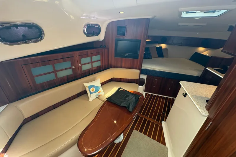 Slide: The Image of Luxurious interior of 2011 Pursuit OS 375 Offshore boat with cozy seating and elegant wood finishes. - 34