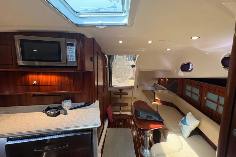 Slide: The Image of Luxurious interior of 2011 Pursuit OS 375 Offshore boat with modern amenities and seating. - 36