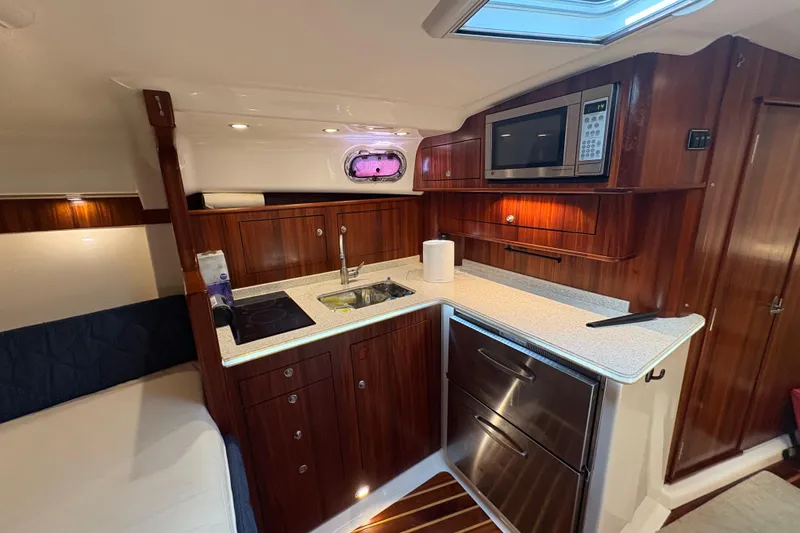 Slide: The Image of Luxurious 2011 Pursuit OS 375 Offshore yacht interior with modern kitchen amenities. - 37