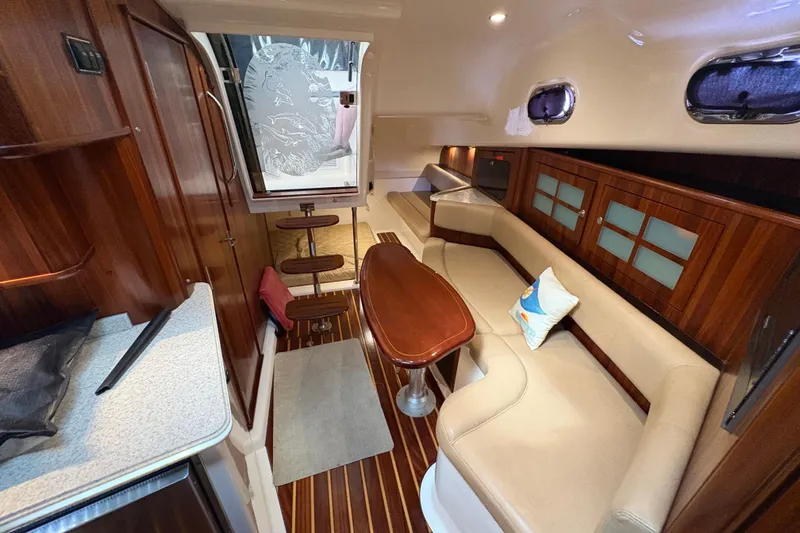 Slide: The Image of Luxurious interior of 2011 Pursuit OS 375 Offshore boat with wood accents and seating. - 41