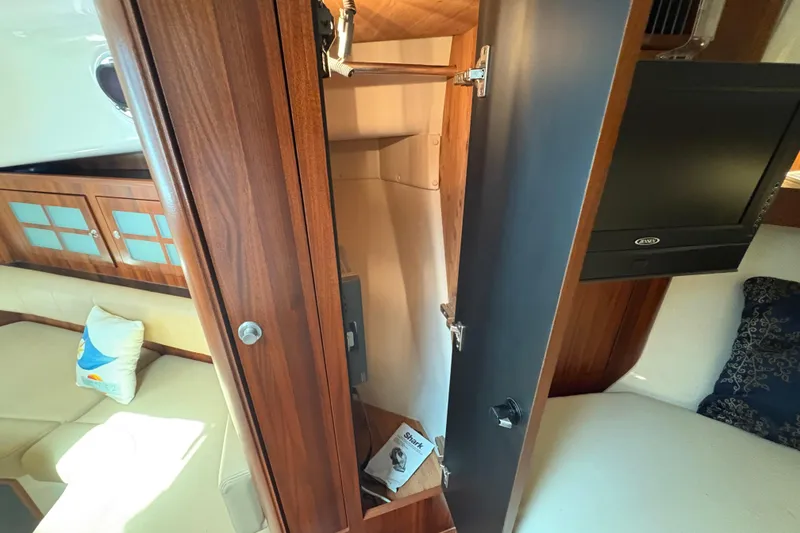 Slide: The Image of Interior of 2011 Pursuit OS 375 Offshore boat with wooden cabinetry and seating area. - 44