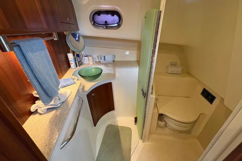 Slide: The Image of Luxurious bathroom in 2011 Pursuit OS 375 Offshore boat with modern amenities. - 46