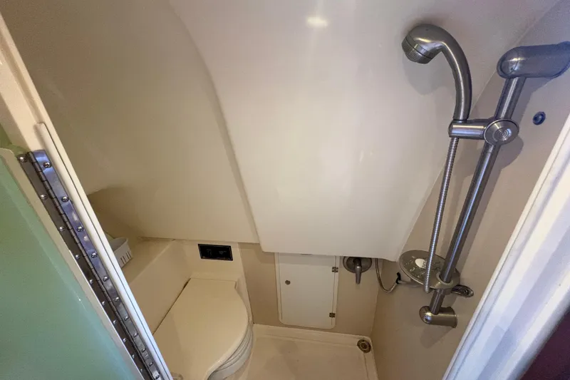 Slide: The Image of 2011 Pursuit OS 375 Offshore bathroom with shower and toilet. - 49