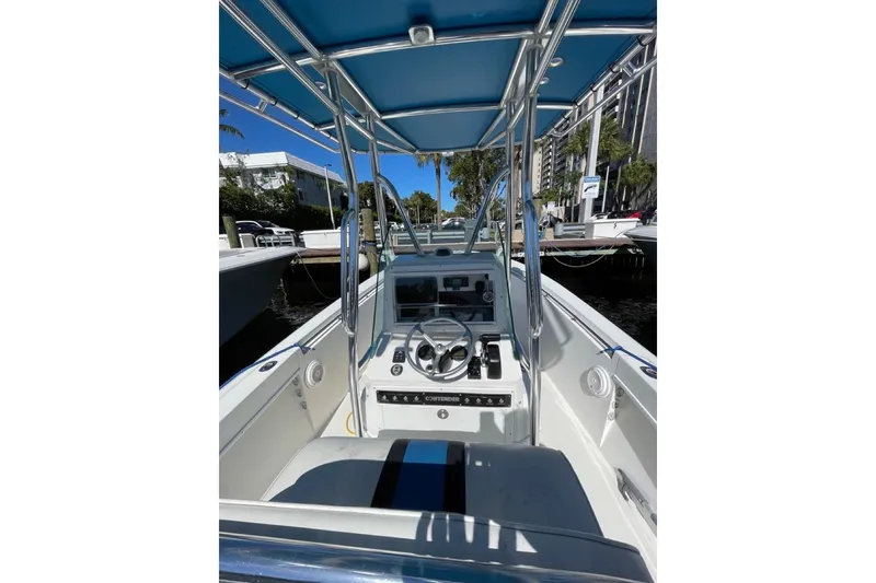 Slide: The Image of 1995 Contender 21 CC boat interior with steering console and blue canopy. - 4