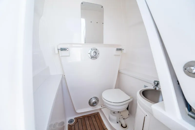 Slide: The Image of 2015 Intrepid 375 Center Console boat bathroom with toilet and sink. - 10