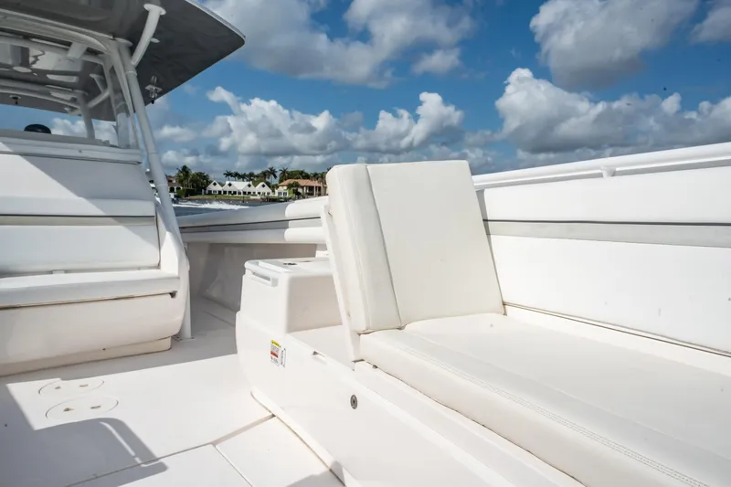 Slide: The Image of 2015 Intrepid 375 Center Console boat interior with white seating under a blue sky. - 11