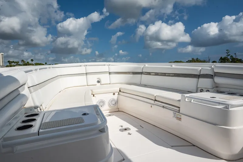 Slide: The Image of 2015 Intrepid 375 Center Console boat interior with white seating under a cloudy sky. - 12