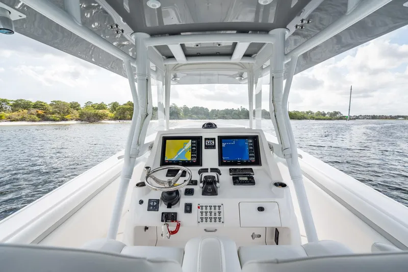 Slide: The Image of 2015 Intrepid 375 Center Console boat dashboard with navigation screens on open water. - 14