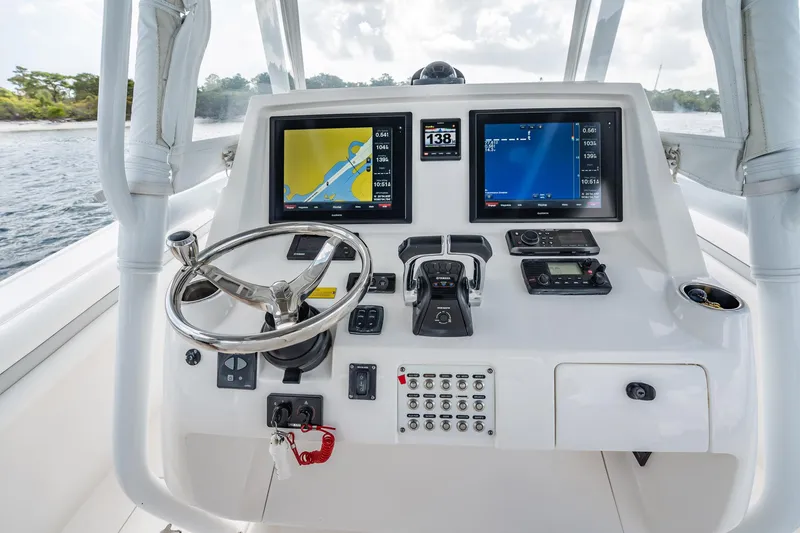 Slide: The Image of 2015 Intrepid 375 Center Console helm with navigation screens and controls. - 15