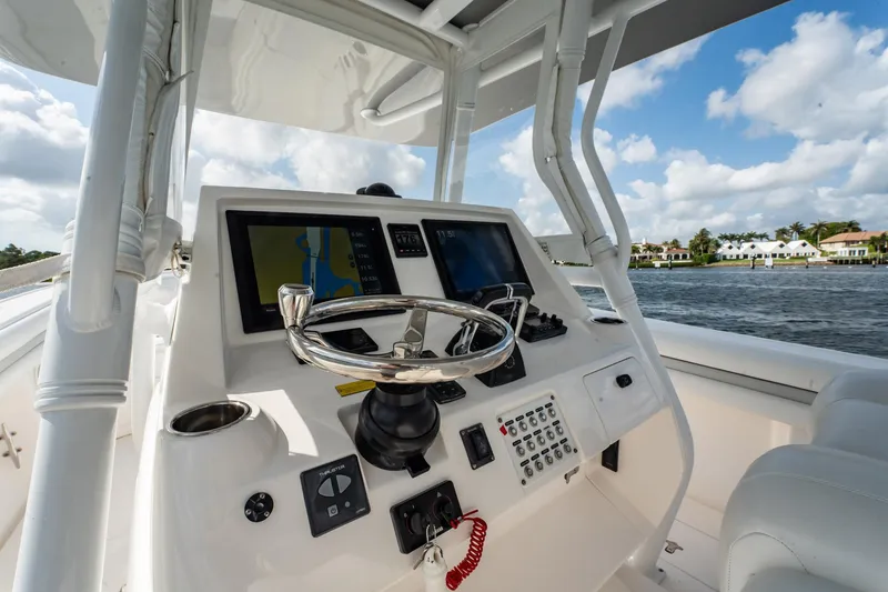 Slide: The Image of 2015 Intrepid 375 Center Console helm with navigation screens and steering wheel. - 17