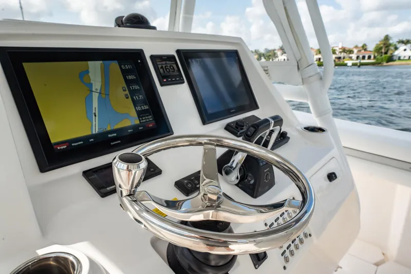 Slide: The Image of Control panel of a 2015 Intrepid 375 Center Console boat with navigation screens. - 18