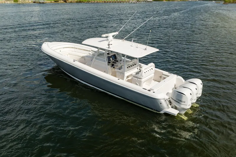 Slide: The Image of 2015 Intrepid 375 Center Console boat on water with triple Yamaha engines. - 3